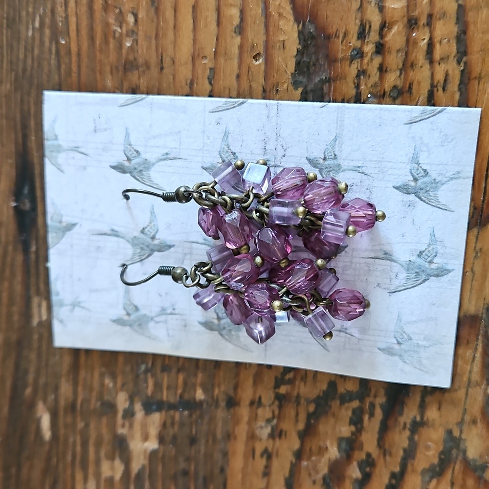Antiqued metal with bubbled purple tinted size and shaped beads..Measures 2 inch